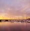 Scenic view of private yachts docked in water harbor at sunset in Bodo, Norway. Nautical transport vessels and boats in