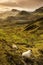 Scenic view of Quiraing mountains in Isle of Skye, Scottish highlands, United Kingdom. Sunrise time with colourful an rayini