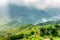 Scenic view of rays of sunlight through clouds in mountains