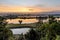 Scenic view of a reflective river and a foggy field with trees at sunrise