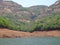 Scenic view of river backwater in hills and mountains greenery