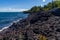 Scenic view of rocky shore of Lake Superior covere with greenery on the Keweenaw peninsula, Michigan