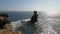 Scenic view of the sea and coastline rocks with plants under the blue clear sky in Peniche, Portugal