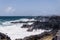 Scenic view of sea waves crashing against rocky cliffs in Azores islands, Portugal