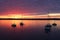 Scenic view of silhouetted yachts against colorful after sunset