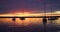 Scenic view of silhouetted yachts against colorful after sunset