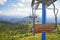 Scenic view of ski lift over field and forest in Carpathian mountains