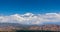 Scenic view of snow capped peak El Plata 6100 MSL above the clouds, as seen from Lake Potrerillos, in Mendoza, Argentina