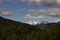 Scenic view of a snow-covered mountaintop and dense forest at Narrow Fjord in Vestland, Norway