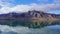 Scenic view of snowcap mountain and its reflection in lake against blue cloudy sky in New Zealand