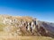 Scenic view of the steep rocky cliffs of Mount VlaÅ¡iÄ‡ in autumn during a sunny day