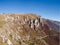 Scenic view of the steep rocky cliffs of Mount VlaÅ¡iÄ‡ in autumn during a sunny day