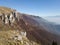 Scenic view of the steep rocky cliffs of Mount VlaÅ¡iÄ‡ and the valley filled with fog in autumn during a sunny day