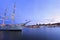 Scenic view of Stockholm`s Old Town Gamla Stan at dusk with illuminated old ship on the foreground