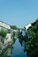 Scenic view of a street corner featuring an array of traditional terraced houses between a canal