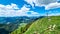 A scenic view on summit cross of Goli Vrh and the mountains of Kamnik Savinja Alps in Carinthia, border Austria and Slovenia