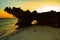 Scenic view of sunset at Watamu Beach seen through a hole on a coral rock in Watamu, Kilifi County, Kenya