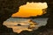 Scenic view of sunset at Watamu Beach seen through a hole on a coral rock in Watamu, Kilifi County, Kenya