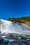 Scenic view of Tannforsen waterfall in Sweden on a sunny day