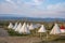 Scenic view of teepees on field with sky in background at Yellowstone park