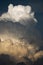 Scenic view of thunderstorm building cumulus clouds with orange sunlight in the Austrian Alps.