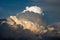 Scenic view of thunderstorm building cumulus clouds with orange sunlight in the Austrian Alps.