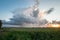 Scenic view of a thunderstorm over wide open flat landscape at sunset