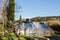 Scenic view to beautiful glass greenhouse at green hills against blue sky in spring in Slovenian coast.