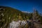 Scenic view from the top of the Stadelwandgrat to Schneeberg, white rocks and pine trees with great blue sky