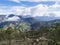 Scenic view from top of Tamadaba natural park with green hills, forest mountains and dam lake. Gran Canaria, Canary