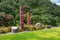 Scenic view of tribal Maori carvings in the Whakatane park surrounded by evergreen hills