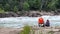 Scenic view of two people sitting near Niagara River in Whirlpool State Park, USA