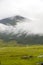 Scenic view of a valley on a cloudy day in Bhutan, landscape with clouds over the mountains.