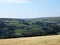 Scenic view of west yorkshire countryside with the village of luddenden at the bottom of the calder valley with buildings