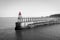 Scenic view of Whitby Pier in sunny autumn day in black and white.Whitby is a seaside town and port in North Yorkshire, UK. Its at
