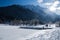 Scenic view on wonderful frozen lake jasna with footbridge in julian alps in blue sky, kranjska gora, Slovenia