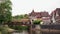 Scenic view of wooden pedestrian bridge over Kocher River and traditional half-timbered old center of Schwabisch Hall