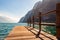 Scenic view on wooden planks pier with railings built on northern shore of beautiful Garda lake in Lombardy, Italy surrounded by