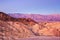 Scenic view from Zabriskie Point, showing convolutions, color contrasts, and texture in the eroded rock at dawn, Amargosa Range,