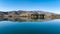 Scenic views of the tranquil Wairepo arm lagoon which is part of Lake Ruataniwha near the village of Twizel at dawn