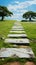 Scenic walkway on vibrant green grass, creating a peaceful atmosphere