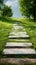 Scenic walkway on vibrant green grass, creating a peaceful atmosphere
