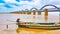 Scenic wide view of arch railway bridge on a river.