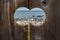 Scenic wildlife and nature with water, birds and seals seen through a wooden peephole.