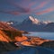 Scenic winding road along Lake Pukaki to Mount Cook National Park, South Island, New Zealand during cold and windy autumn morning.