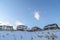 Scenic winter day on a neighborhood with houses on snowy mountain slope