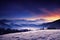 Scenic winter landscape of night sky over mountain range.