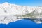 Scenic winter mirror reflection of snowcap mountain and Wizard Island on Crater Lake