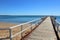 Scenic wooden dock on a tranquil sandy beach in Hervey Bay, Queensland, Australia