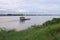 Scenics of the Mekong river in the cloudy day with cargo ship.